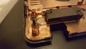 Hot glue used, as will break under stress. Protects other components from shock.
